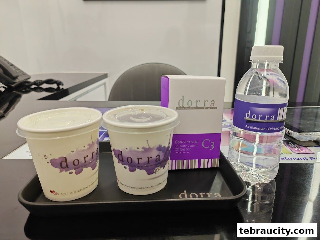 Two cups, a box of Dorra C3 concentrate, and a bottle of Dorra drinking water on a tray.