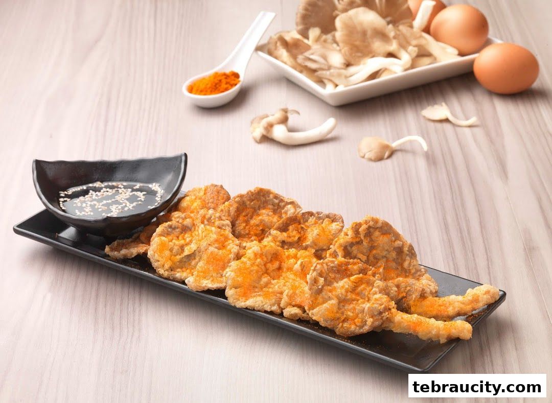 Crispy fried oyster mushrooms seasoned with orange powder, served with dipping sauce and fresh ingredients.