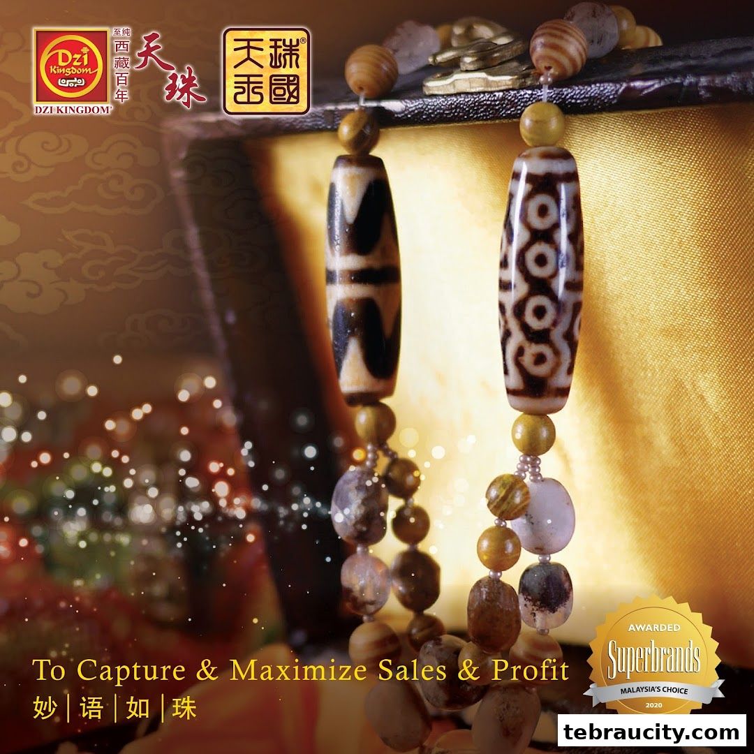 Close-up of two Dzi bead necklaces with intricate patterns, set against a golden background.