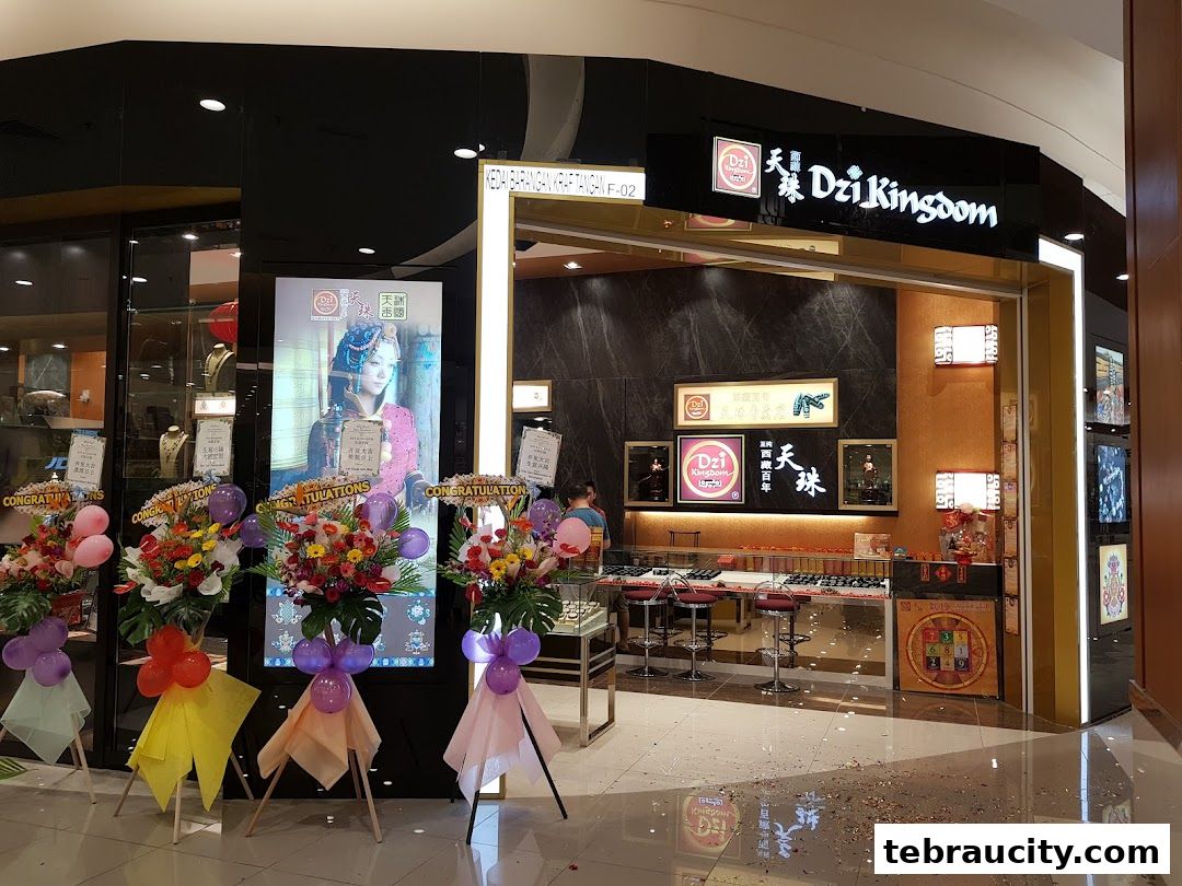 The entrance of Dzi Kingdom shop with congratulatory flower stands and displays of jewelry.