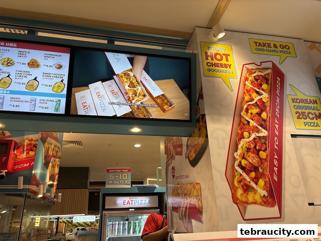 A display showcasing various pizzas and sides from Eat Pizza, with a focus on their Korean-style pizzas.