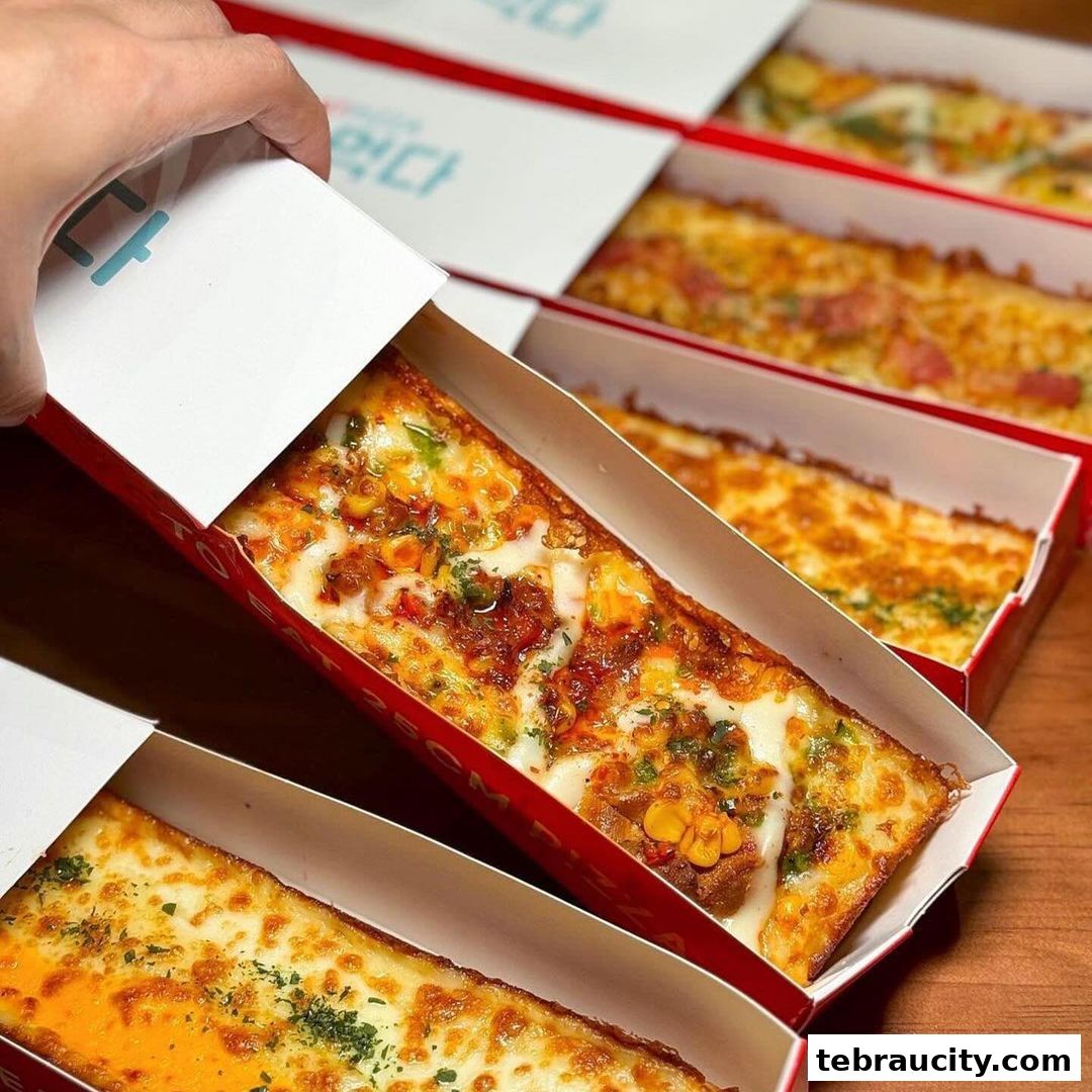 A hand holds a box of delicious, cheesy pizza slices with various toppings.