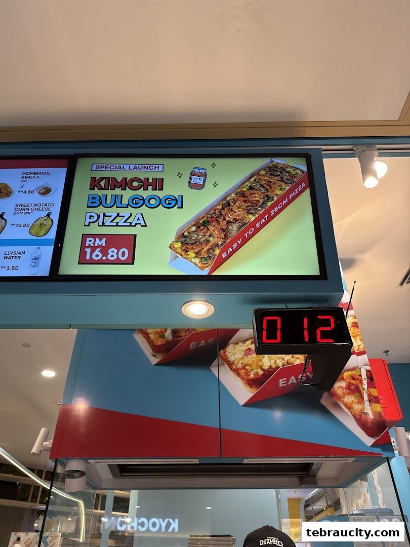 A digital menu board showcasing a special launch of Kimchi Bulgogi Pizza.