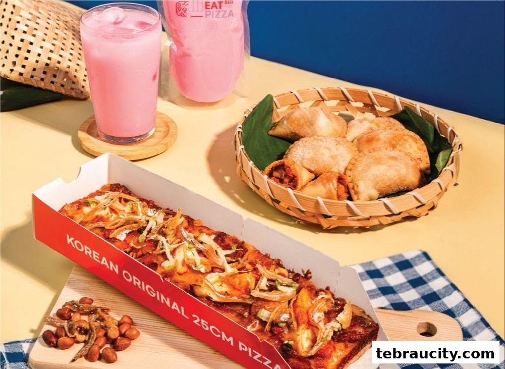 A Korean Original 25cm pizza with a side of pastries and a pink drink.