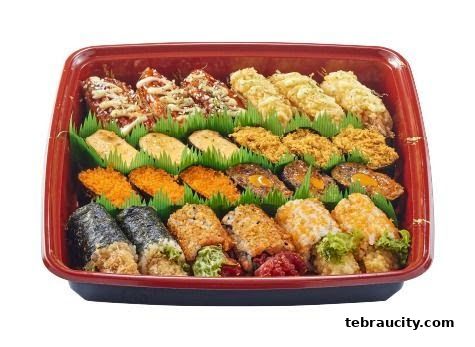 A platter of assorted sushi and maki rolls, beautifully arranged in a red tray.