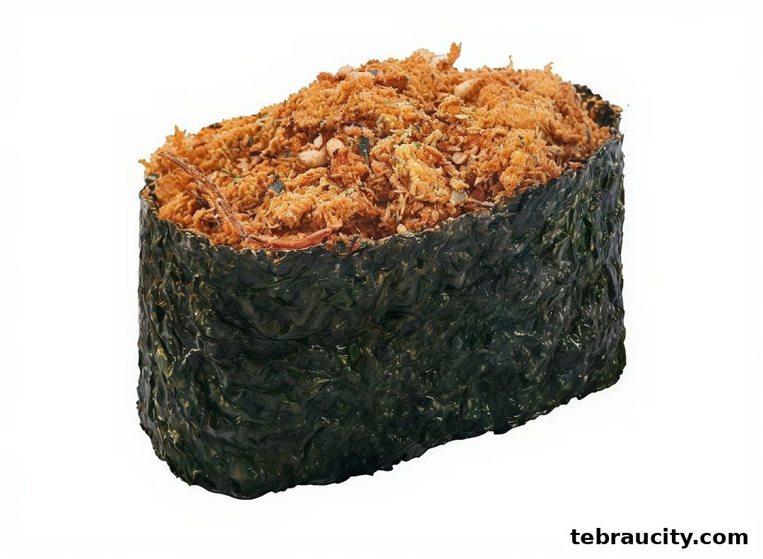A close-up shot of a sushi roll wrapped in nori with a crispy topping.