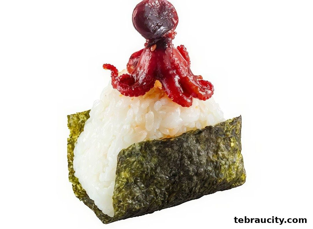 A close-up of a sushi ball topped with a small red octopus and seaweed.