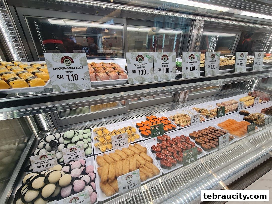 A display case filled with various sushi and mochi items, each with price labels.