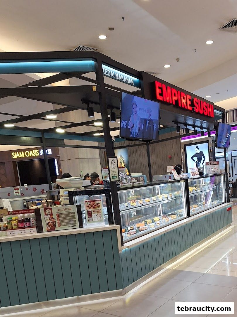 Empire Sushi shop front with display cases filled with sushi and a sign above.