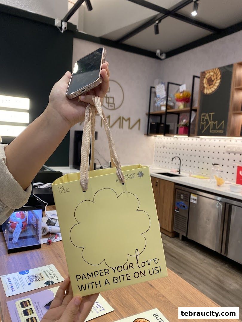 A hand holds a yellow gift bag with 'Pamper Your Love With A Bite On Us!' text.