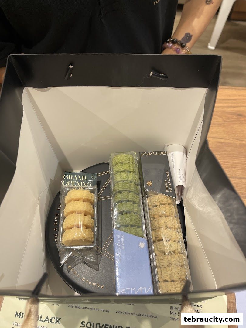 A shopping bag filled with various Fatmama Bakery cookies and treats.