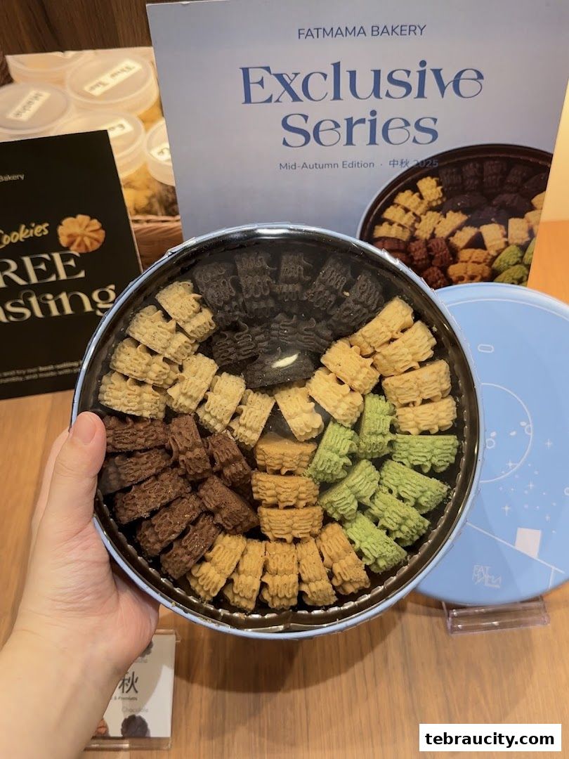 A hand holds a tin of assorted cookies from Fatmama Bakery's Exclusive Series.