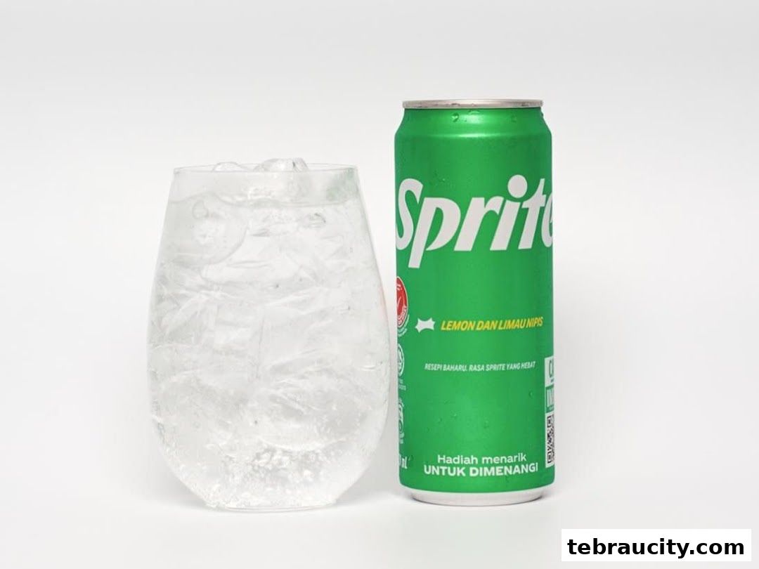 A can of Sprite and a glass of iced beverage on a white background.