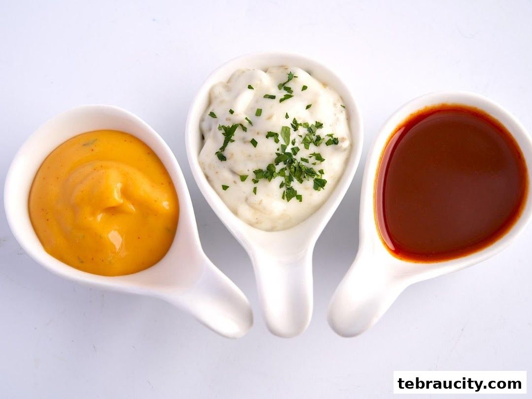 Three white ceramic dishes filled with different sauces and toppings.