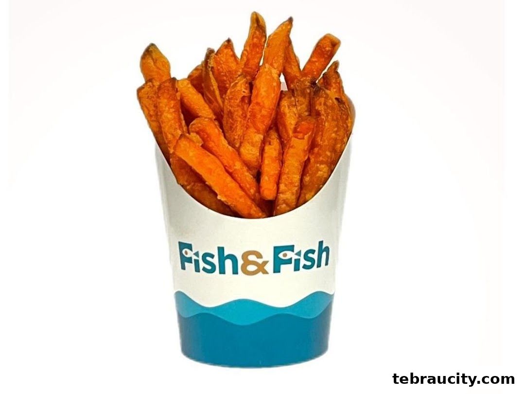 A cup of crispy sweet potato fries with the 'Fish & Fish' logo on the cup.