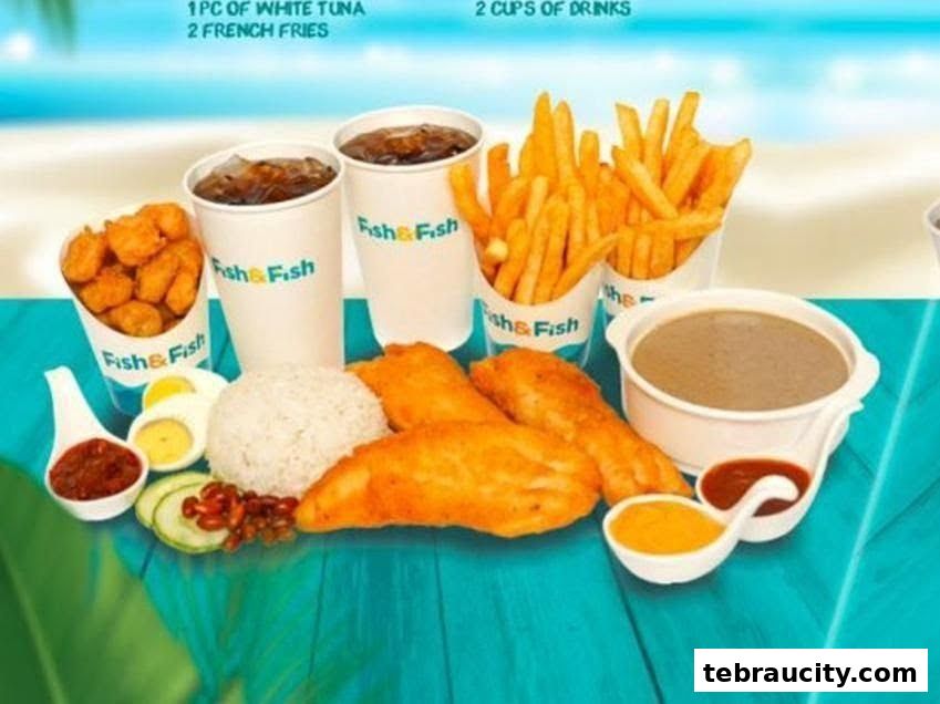 A meal from Fish & Fish featuring fried fish, rice, fries, nuggets, drinks, and sauces.