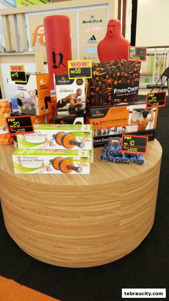 A display of fitness equipment including gym balls, exercise wheels, and a multi-training bar.