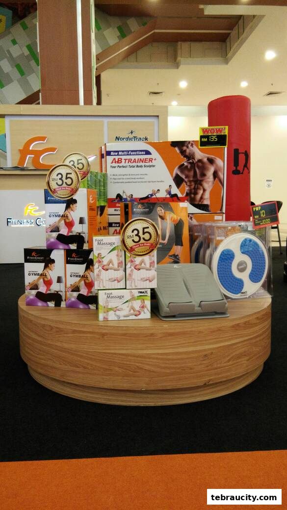 Fitness equipment display featuring an AB TRAINER, gym balls, and foot massagers.