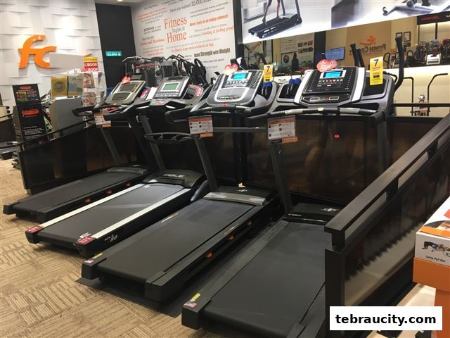 A row of treadmills displayed inside a fitness equipment store.