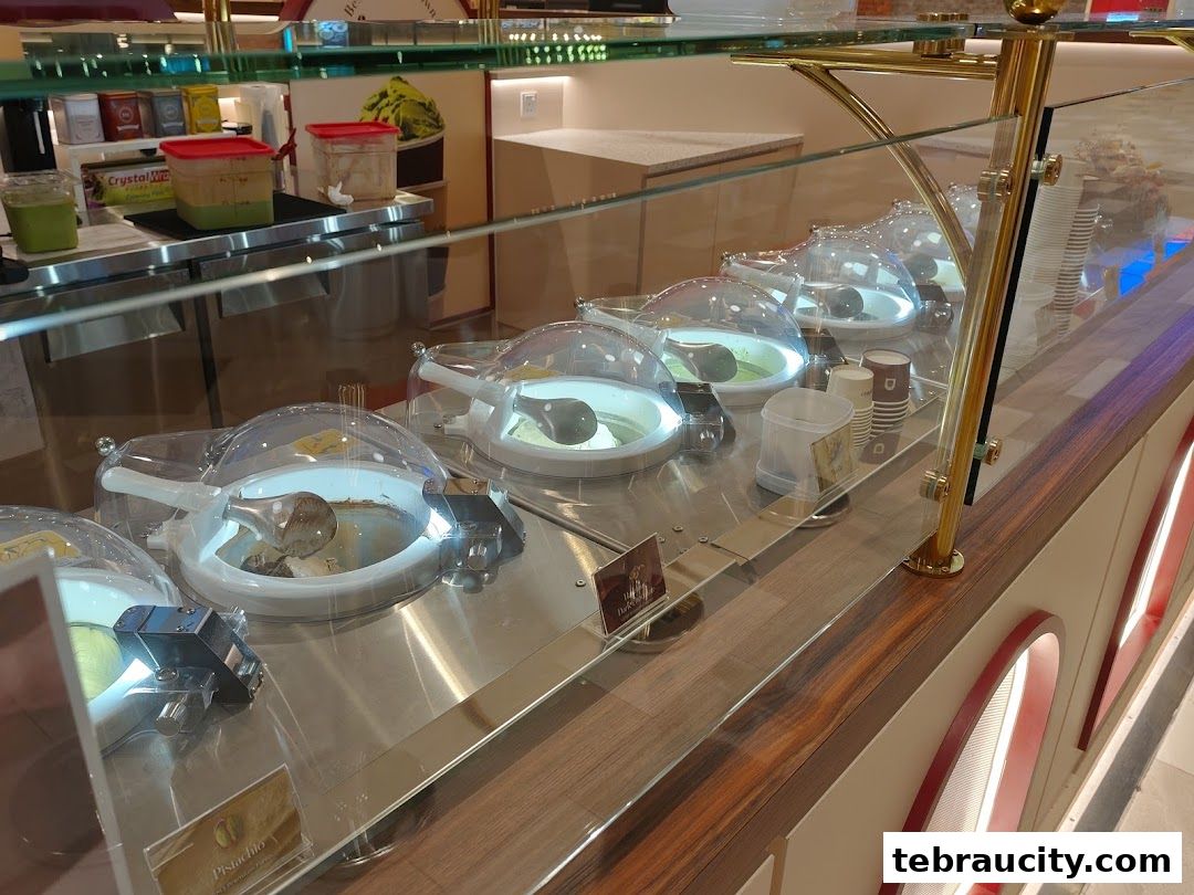 A display of gelato flavors in a shop with a clean, modern aesthetic.