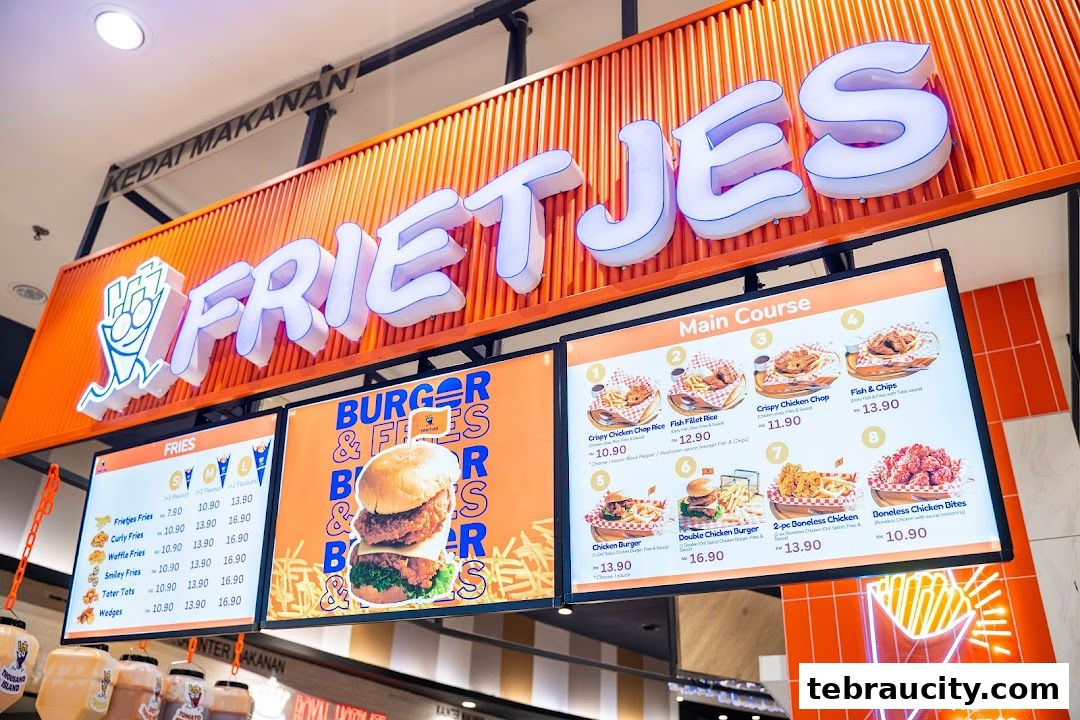 A brightly lit menu board for Frietjes, showcasing fries, burgers, and main courses.