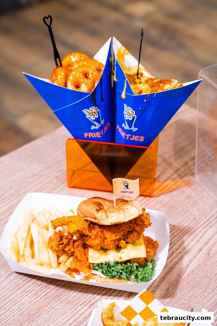 A delicious chicken burger with fries and cheesy bites from Frietjes.