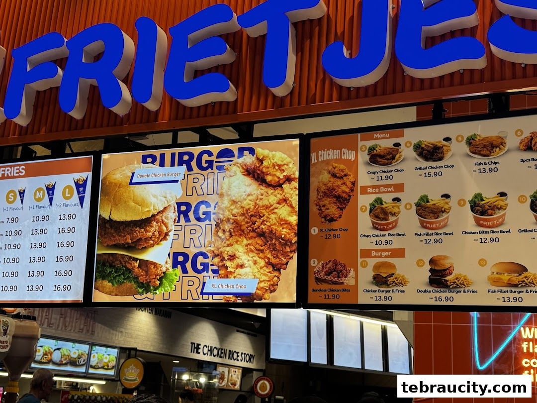 A menu board displaying various fried chicken items, burgers, and rice bowls with prices.