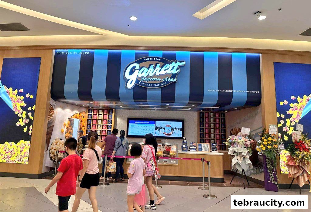People queuing at the entrance of Garrett Popcorn Shops with colorful displays.