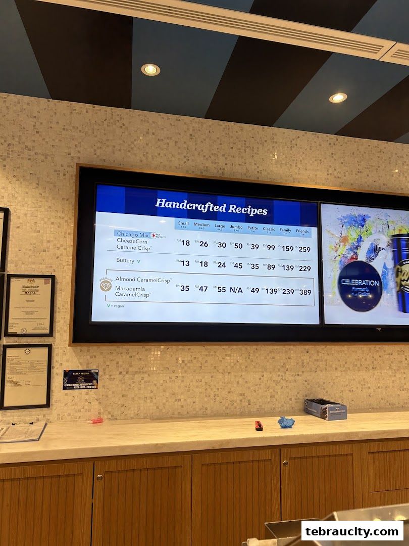 A digital menu board displaying various popcorn flavors and their prices in different sizes.