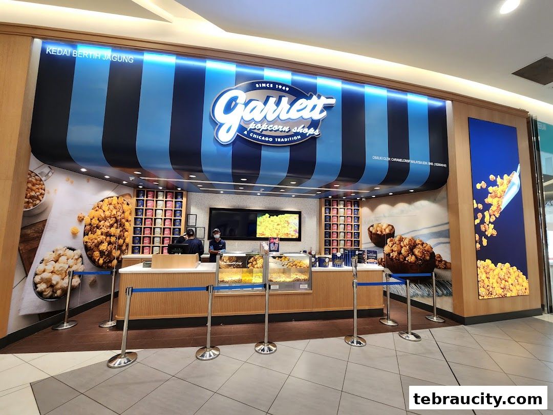 The Garrett Popcorn Shops storefront with colorful popcorn displays and staff serving customers.