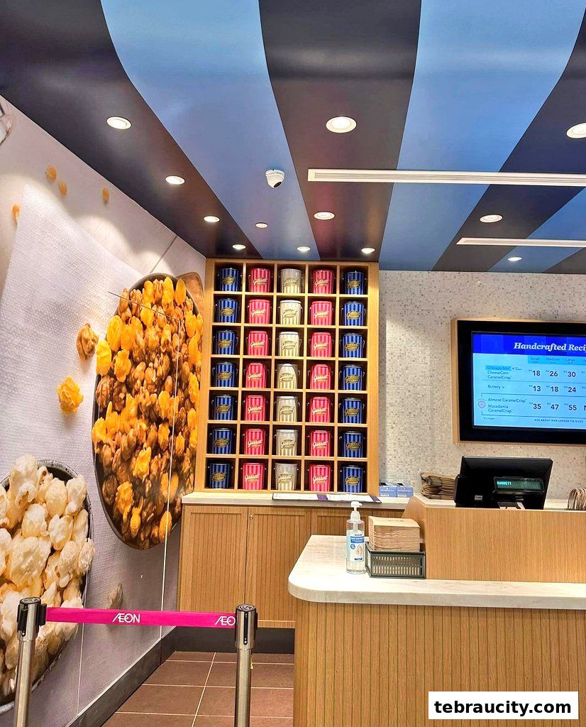 Interior view of Garrett Popcorn Shops with colorful popcorn tins displayed and a digital menu.