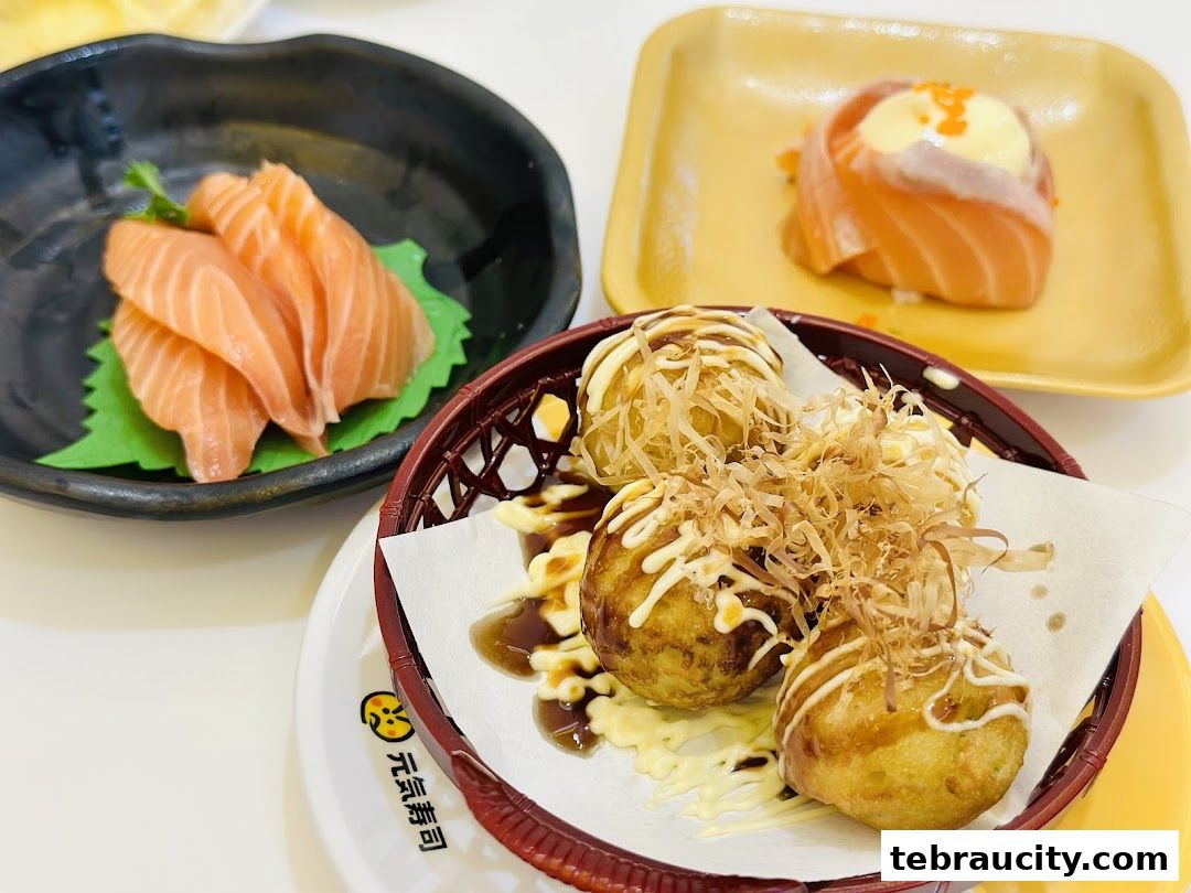 A close-up of delicious Japanese food, including salmon sashimi and takoyaki.