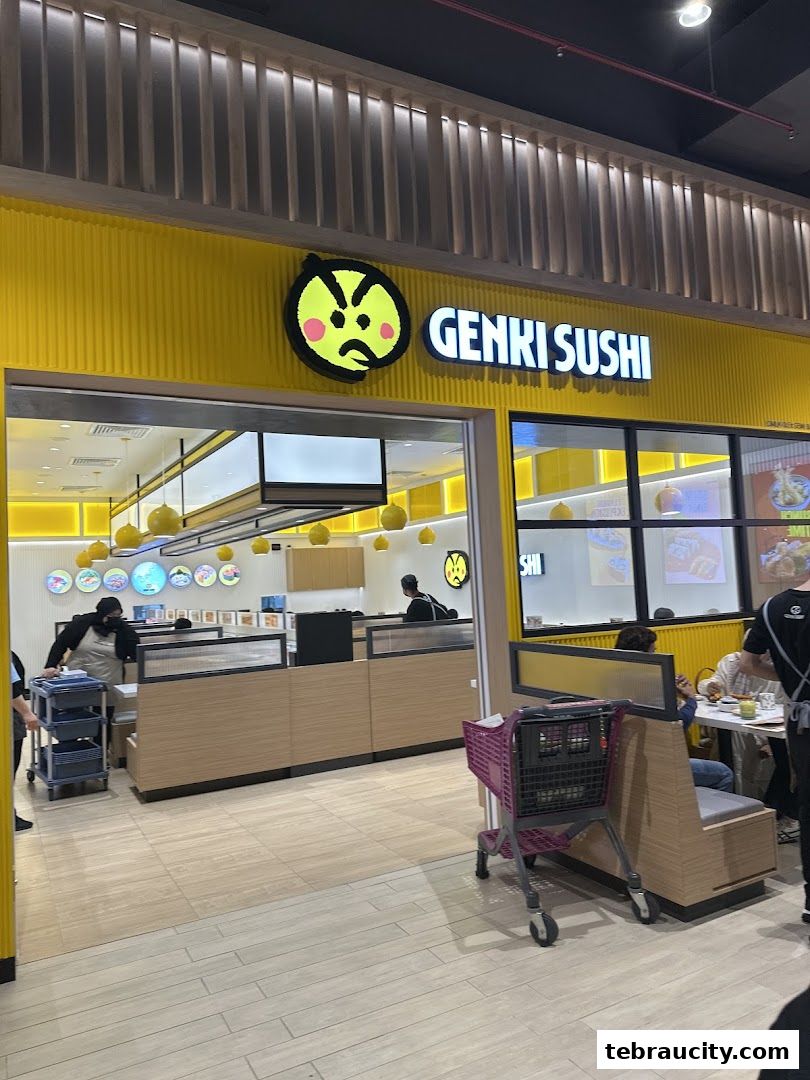 The bright yellow exterior of Genki Sushi with its distinctive logo and entrance.