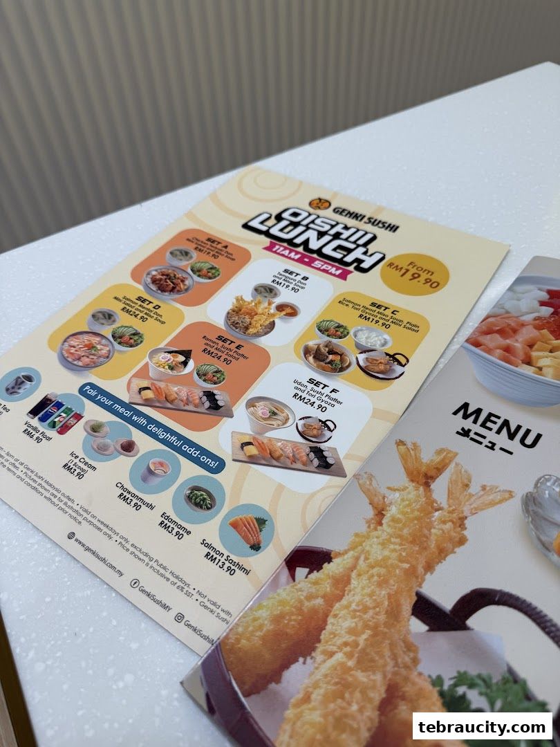 A menu from Genki Sushi featuring lunch sets and add-on items.