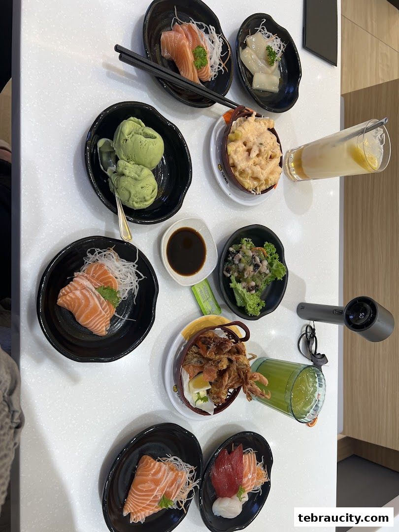 A table filled with various Japanese dishes, including sashimi, ice cream, and drinks.