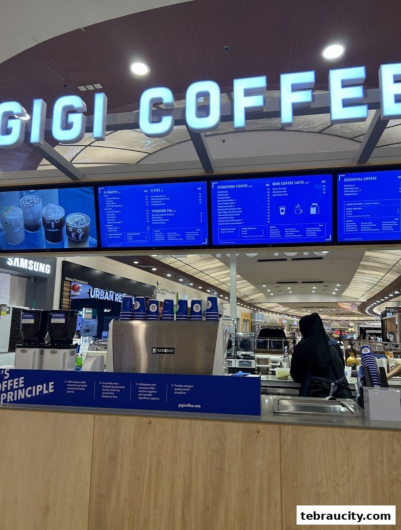 A view of the Gigi Coffee counter with a menu board and coffee machines.