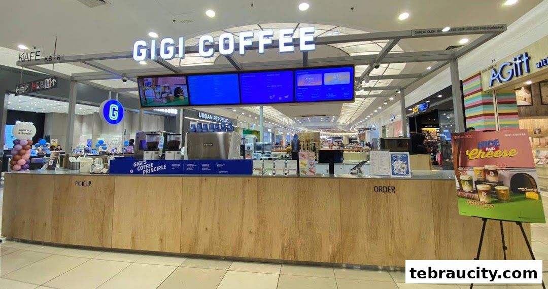 A Gigi Coffee kiosk in a shopping mall with a prominent sign and digital menu boards.