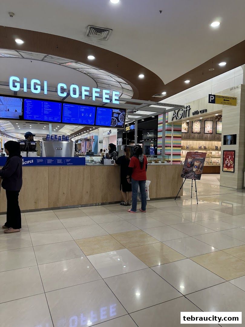 The Gigi Coffee shop front with customers ordering at the counter.