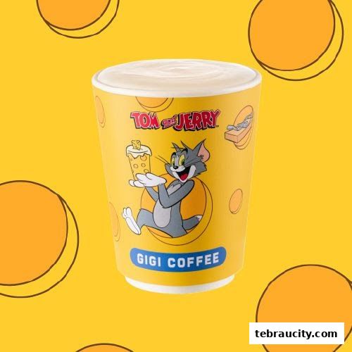 A yellow coffee cup with Tom and Jerry characters and the Gigi Coffee logo.