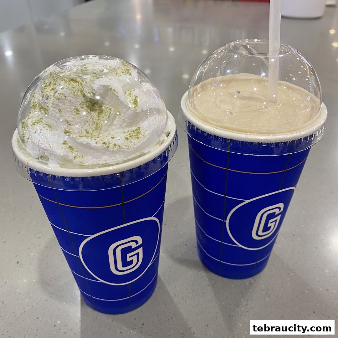 Two refreshing drinks from Gigi Coffee, one with whipped cream and matcha powder.