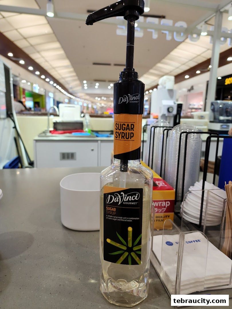 A bottle of DaVinci Gourmet Sugar Syrup with a pump dispenser on a counter.