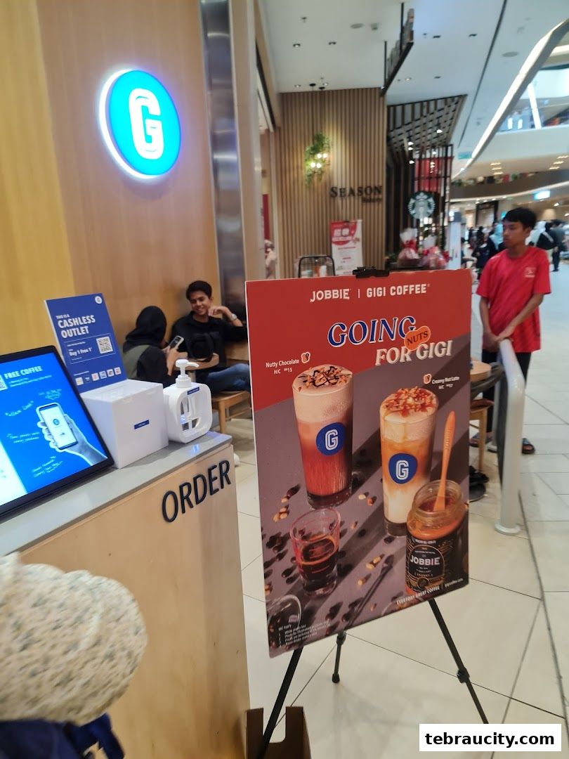 A promotional stand for Gigi Coffee featuring their 'Going for Gigi' campaign with drinks.