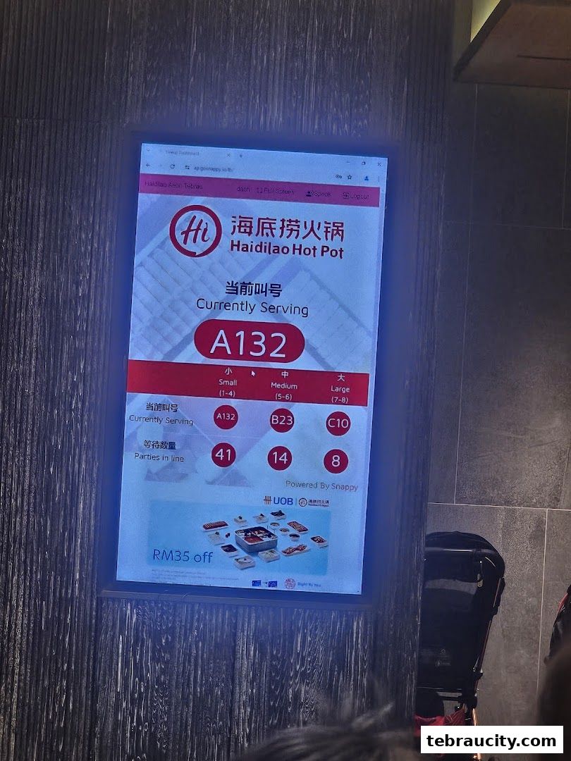 A digital display shows the current waiting number and queue status for Haidilao Hot Pot.