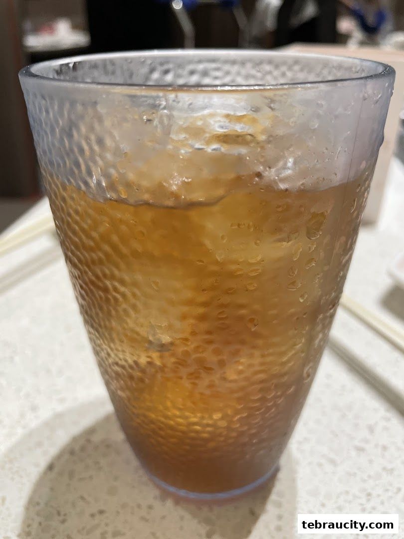 A close-up shot of a textured glass filled with iced tea.