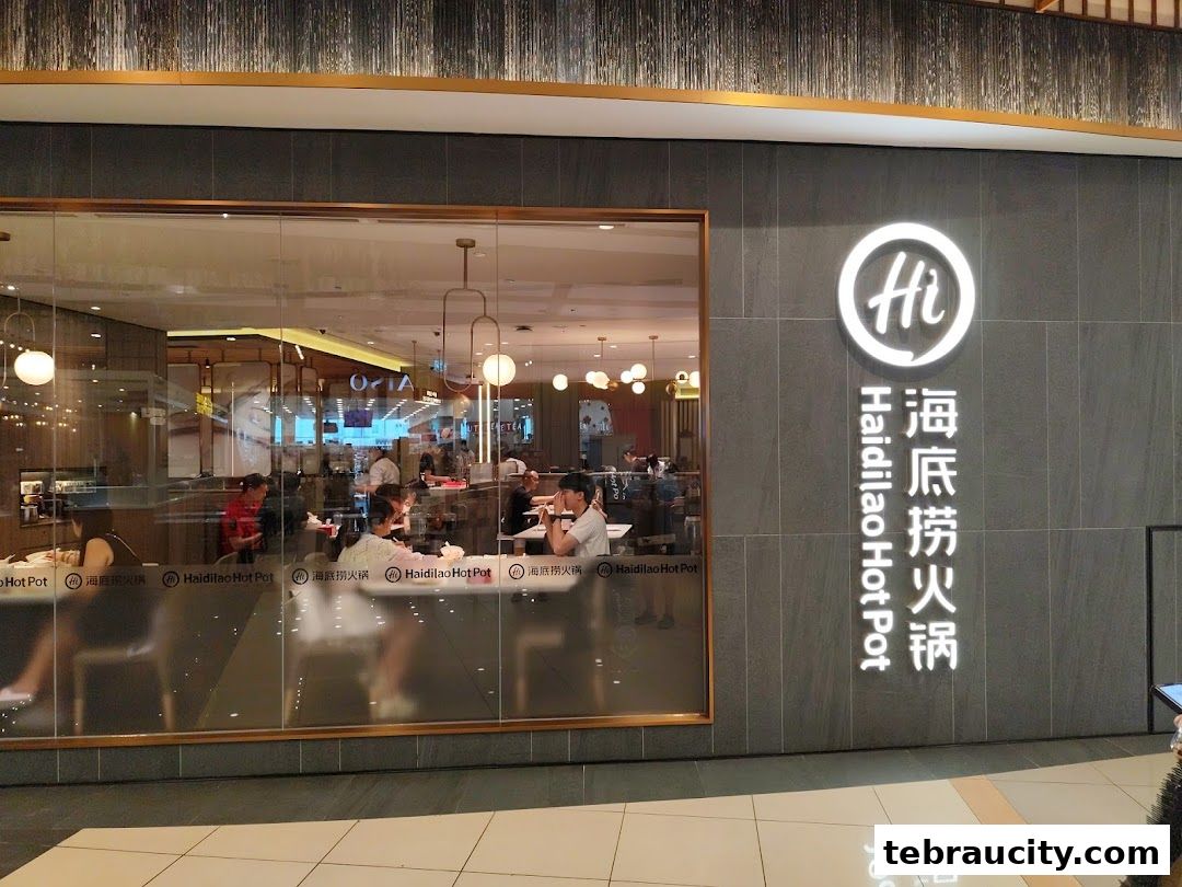 The exterior of Haidilao Hot Pot restaurant with its prominent logo and signage.