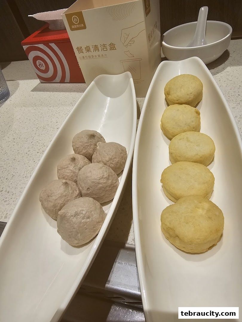 Two white trays hold meatballs and fish balls, with a cleaning kit and bowl in the background.