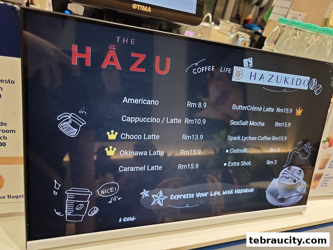 A digital menu board displaying various coffee drinks and their prices at Hazu Bakery Cafe.