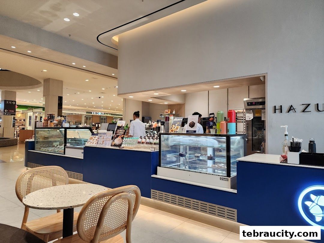 Interior view of Hazu Bakery Cafe with display cases and seating.