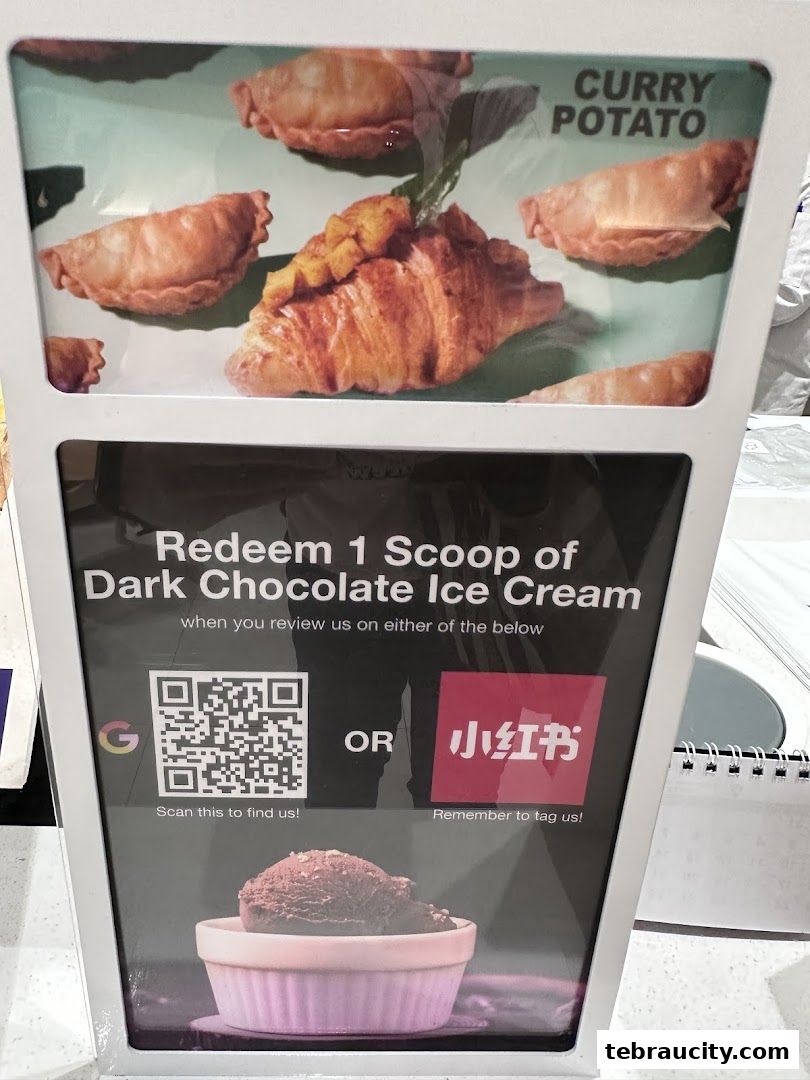 A promotional sign offering a free scoop of dark chocolate ice cream for reviews.