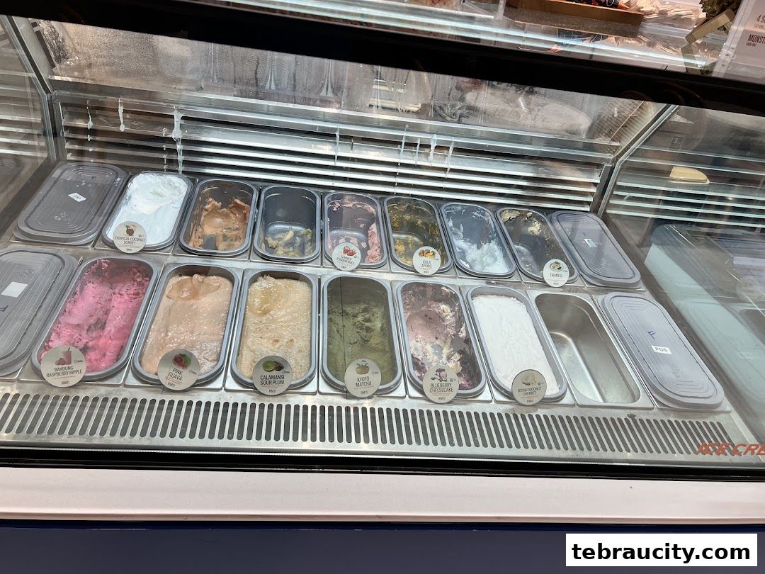 A display case filled with various flavors of ice cream and sorbet.
